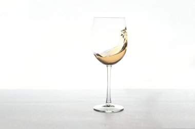 Beyaz arka planda bir bardak beyaz şarap.