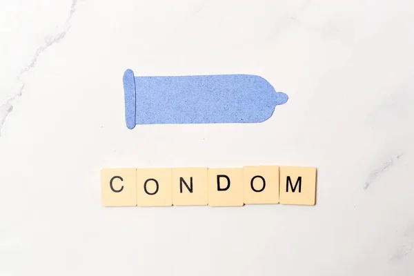 Condom, contraceptive method concept and sexual education.