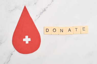 Concept of blood donation. Red paper drop icon, inviting to donate.