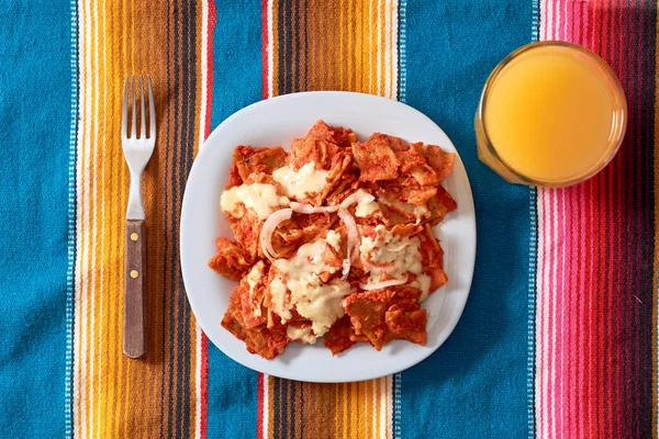 Chilaquiles Mexican breakfast. Made with tortillas and red sauce.