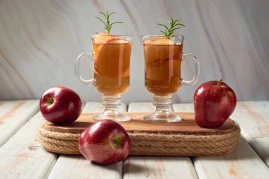 Apple cider or tea in cups, hot beverage for autumn.