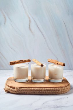 Fresh horchata with cinnamon in glass on rustic table
