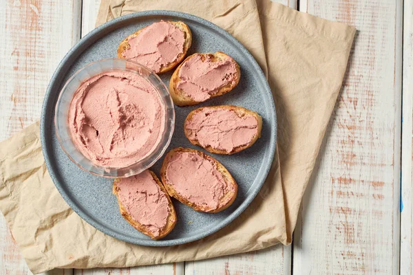 Bread toast with pork liver on a rustic background.