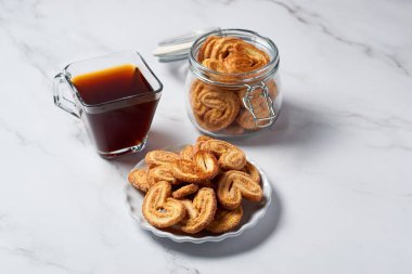 Palmier biscuits french cookies made of puff pastry, also called palm leaves, elephant ears or french hearts