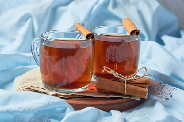 Steaming hot cup of tea with cinnamon