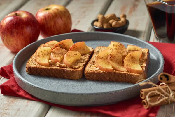 Toasts with peanut butter and apple. Healthy vegetarian breakfast concept.