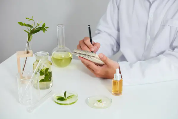 Plants and flowers extract in petri dish and a white background in laboratory , green leaf in a test tube and doctor for cosmetic advertising , photography science concept