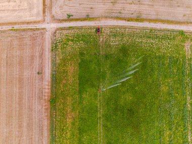 Aerial view of irrigation with sprinkler on dry field, Germany