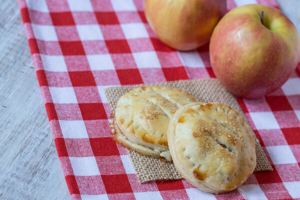 Autumn apple hand pies on red checkered napkin