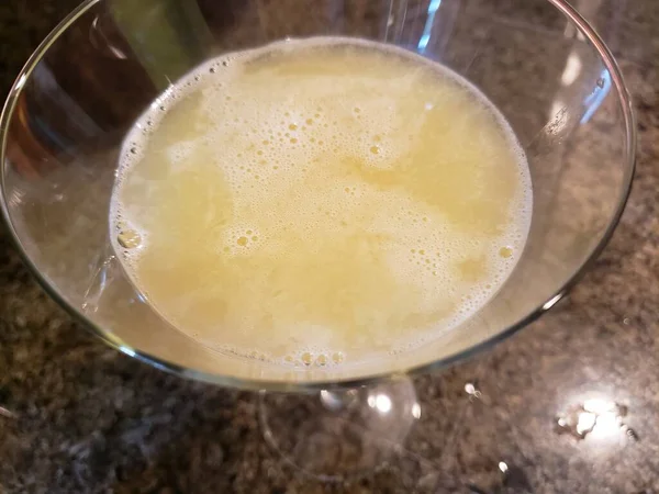 Orange Blossom Cocktail Sitting on a Granite Countertop