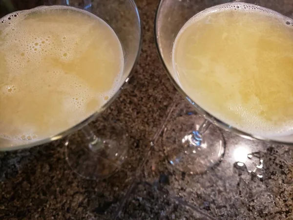 Orange Blossom Cocktail Sitting on a Granite Countertop