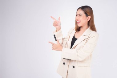 Portrait of young beautiful businesswoman wearing suit in white background studio.	