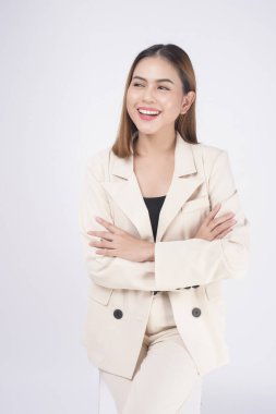 Portrait of young beautiful businesswoman wearing suit in white background studio.	