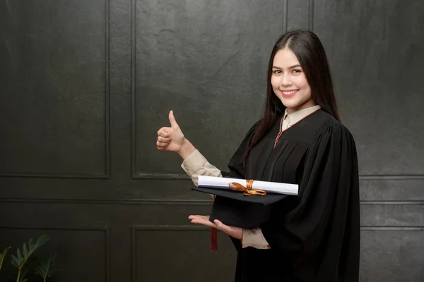 Portrait Young Woman Graduation Gown Smiling Cheering Black Background — Stock Photo, Image