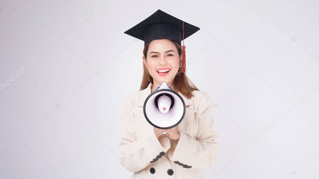 Portrait of young woman graduated over white background	