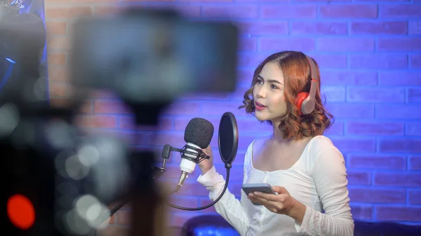 Uma Jovem Cantora Sorridente Usando Fones Ouvido Com Microfone Enquanto — Fotografia de Stock
