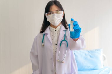 ATK kitini hastanede tutan genç bayan doktor, covid19 ve pandemik konsept