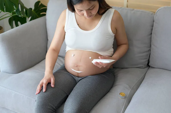 Young Pregnant Woman Applying Moisturizing Cream Tummy Healthcare Pregnancy Care — Foto de Stock