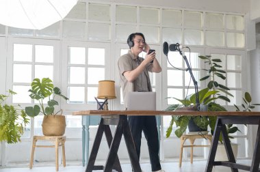 A musician man  is recording new song in home Studio 