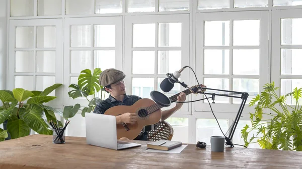 A musician is writing song in home Studio