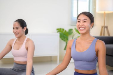 Evde yoga ve meditasyon yapan sağlıklı genç arkadaş kadınlar, spor ve sağlıklı yaşam tarzı konsepti..