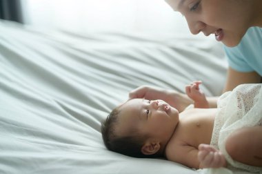 A Young mother with a Cute new born baby.