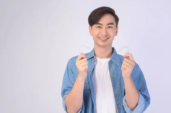 Young Smiling Man Holding Invisalign Braces White Background Studio Dental — Foto de Stock