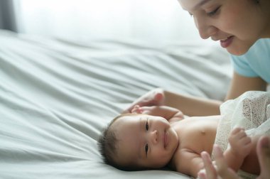 A Young mother with a Cute new born baby.