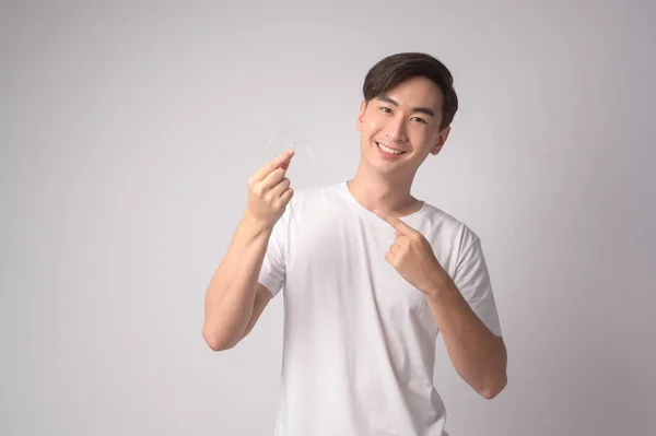 Young Smiling Man Holding Invisalign Braces White Background Studio Dental — Stock Photo, Image