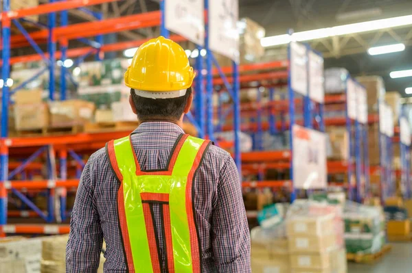 stock image A Portrait of senior asian male worker wearing helmet in modern warehouse storage of retail shop