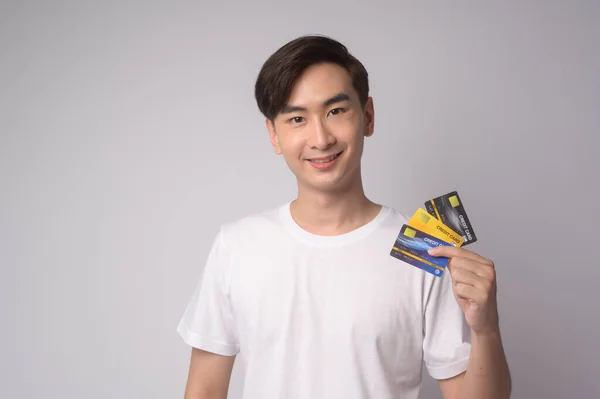 Young Asian Man Holding Credit Card White Background Studio Shopping — Stok fotoğraf