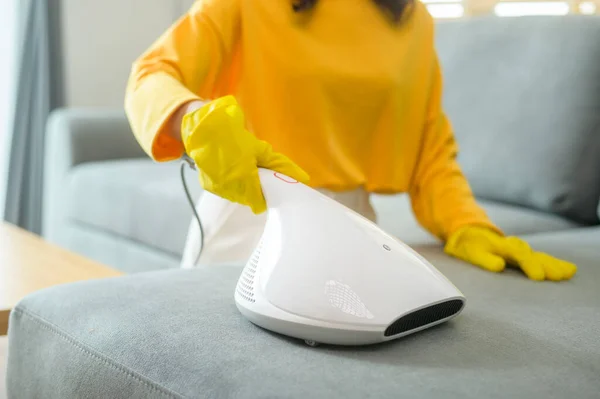 Young Happy Woman Wearing Yellow Gloves Vacuum Cleaning Sofa Living — Stock fotografie