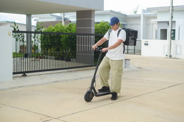 Smiling Delivery Man Thermal Backpack Riding Electric Scooter Deliver Online — Stock Photo, Image