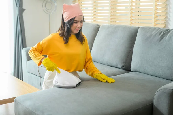 Young Happy Woman Wearing Yellow Gloves Vacuum Cleaning Sofa Living —  Fotos de Stock