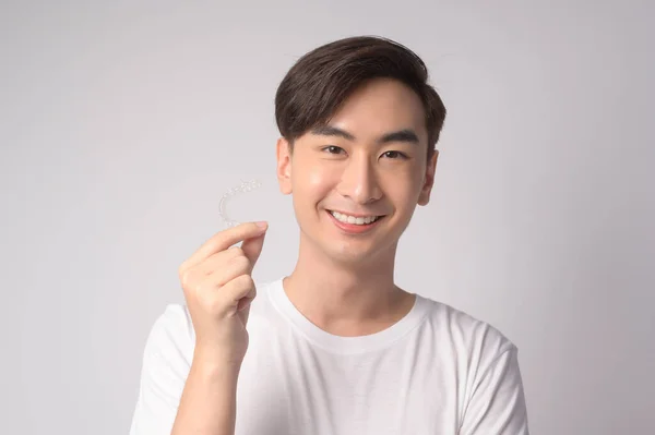 Young Smiling Man Holding Invisalign Braces White Background Studio Dental — Fotografia de Stock