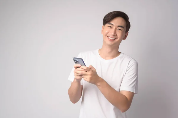 Young Asian Man Using Smartphone White Background Technology Concept — стоковое фото