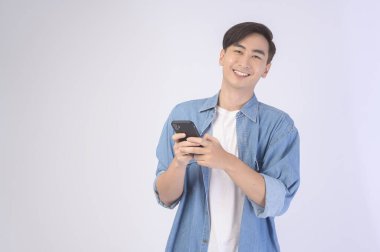 A Young asian man using smartphone over white background, technology concept. 		