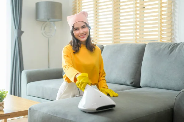 Young Happy Woman Wearing Yellow Gloves Vacuum Cleaning Sofa Living — Stockfoto