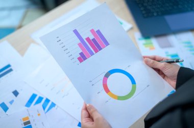 Top view of Documents with analytics data lying on table,selective focus	