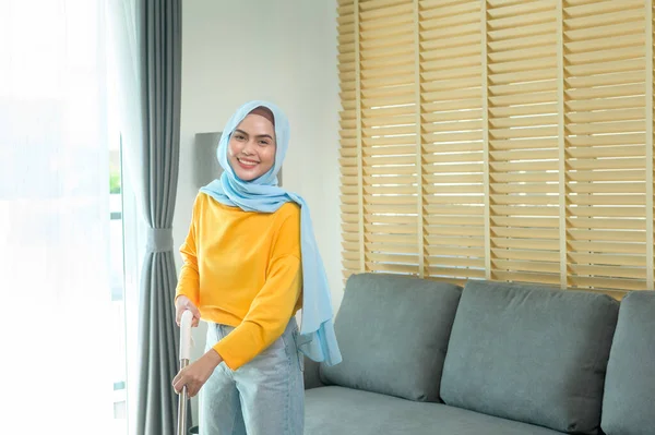 Young Happy Muslim Woman Mopping Vacuum Floor Living Room —  Fotos de Stock