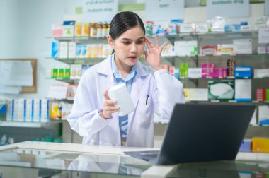 A Female pharmacist counseling customer via video call in a modern pharmacy drugstore.