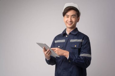 A Portrait of male engineer wearing a protective helmet over white background studio.
