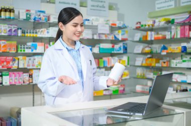 A Female pharmacist counseling customer via video call in a modern pharmacy drugstore.