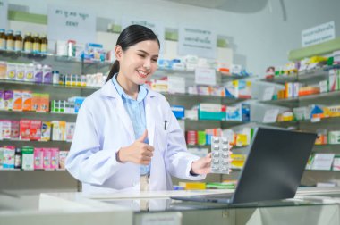 A Female pharmacist counseling customer via video call in a modern pharmacy drugstore.