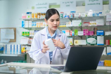 A Female pharmacist counseling customer via video call in a modern pharmacy drugstore.