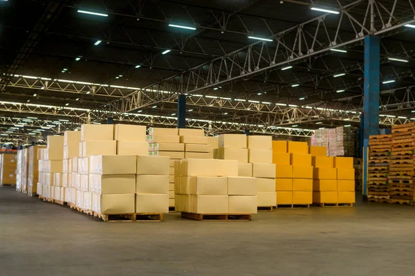 Inventory full of cardboard boxes in modern warehouse storage of retail shop.