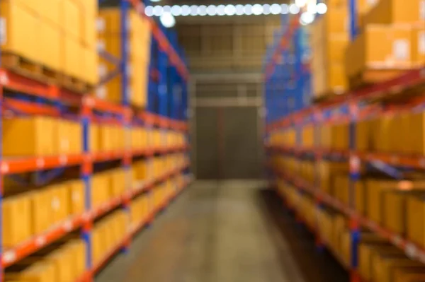 Blurred background of Inventory full of shelves in modern warehouse storage of retail shop.