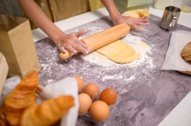A Close up of Young beautiful woman is baking in her kitchen , bakery and coffee shop business