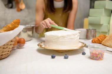 A Close up of Young beautiful woman is baking in her kitchen , bakery and coffee shop business