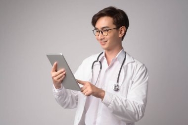 Portrait of male confident doctor over white background studio, healthcare and Medical technology concept.